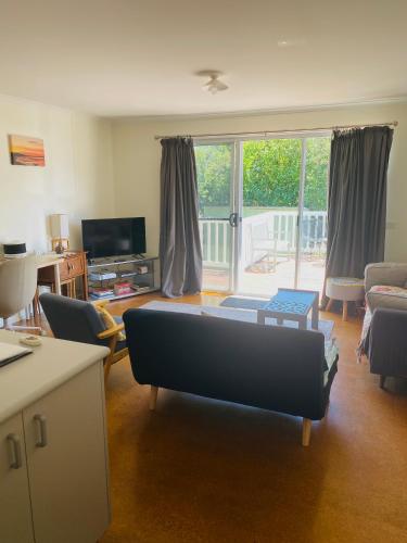 a living room with a couch in the middle of it at Phillip Island Beach House - Relaxed - Close to Beach - Pet Friendly in Cowes