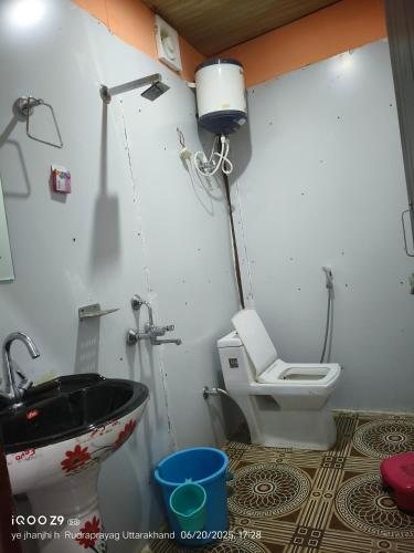 a bathroom with a sink and a toilet at shiv shankar resort and hotel in Phata