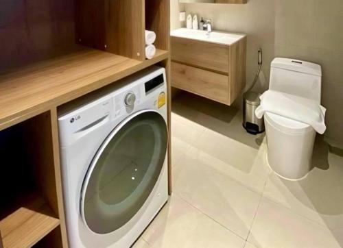 a washing machine in a bathroom with a toilet at Velea Serviced Apartments & Suites in Siem Reap
