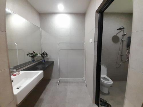 a bathroom with a tub and a sink and a toilet at Teratak Assofiyya 4 Bilik in Sungai Petani