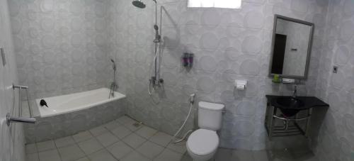 a bathroom with a shower and a toilet and a sink at Mata Ie Resort in Sabang