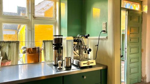 a kitchen with a coffee maker on a counter at Historic Farmhouse From 1848 in Hårby