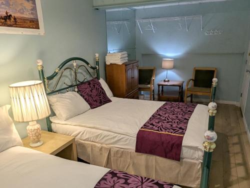 a bedroom with two beds and a table and chairs at Calgary Star Cozy Home in Calgary