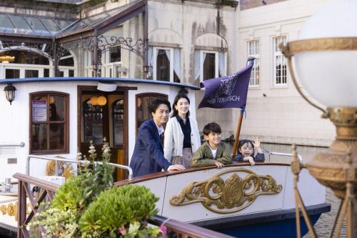 a group of people riding on a small boat at Hotel Europe Huis Ten Bosch in Sasebo