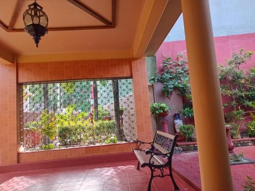 a patio with a chair in front of a window at The Garden Villa in Matara