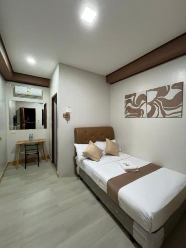 a bedroom with a bed and a table in it at Elejea's Inn in Sinai