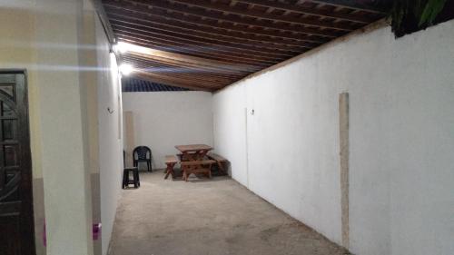 an empty room with a table and a ceiling at Casa com piscina in Marechal Deodoro