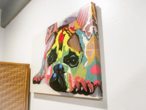 a painting of a dog on a wall at Metro Pratunam Boutique Hotel in Pratunam