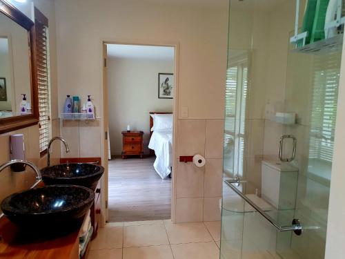 a bathroom with two sinks and a shower at Lily Pad Apartment in Motueka