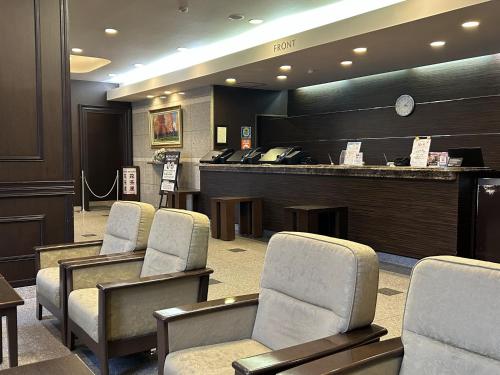 a waiting room with chairs and a reception counter at Hotel Route-Inn Dai-ni Suwa Inter in Suwa