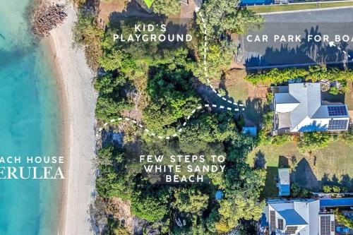 an aerial view of a beach with a white sandy beach at Absolute Beachfront with Ocean Views 3 Beds plus Pool in Hideaway Bay
