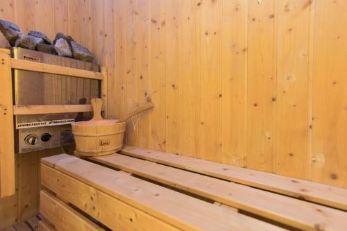 a wooden sauna with a wooden bucket on a shelf at Hotel Alexandros in Doxato