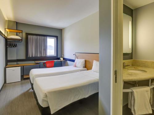 a hotel room with two beds and a sink at ibis Rio de Janeiro Nova America in Rio de Janeiro