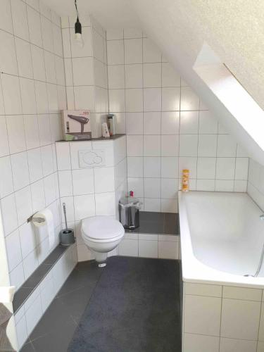 a bathroom with a toilet and a bath tub at notre petit paradis in Winnenden
