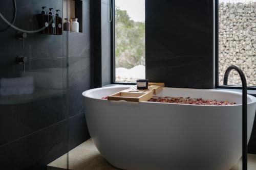 a white bath tub in a bathroom with a window at The Dunes in Island Beach