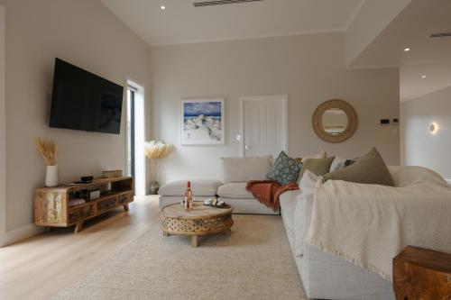 a living room with a couch and a table at The Dunes in Island Beach