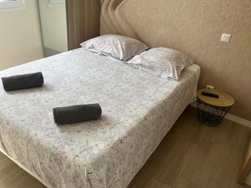 a bed with two pillows on it in a bedroom at Studio climatisé SPA en option in Jacou