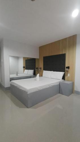 a large bedroom with a large white bed in it at D New Inn Mactan in Lapu Lapu City