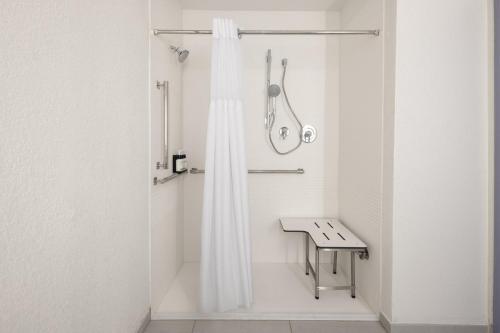 a bathroom with a shower with a shower curtain at Garner Hotel Mahwah by IHG in Mahwah