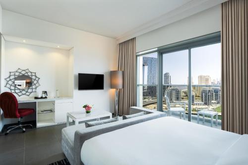 a hotel room with a bed and a large window at The First Collection Marina, Dubai, a Tribute Portfolio Hotel in Dubai