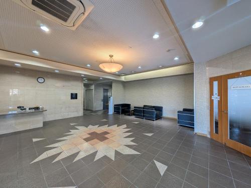 a lobby with a waiting room with a clock on the ceiling at Green Rich Hotel Aso Kumamoto Airport (Artificial hot spring Futamata Yunohana) in Kikuchi