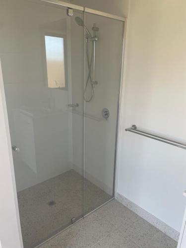 a shower with a glass door in a bathroom at Southern Retreat in Clyde North