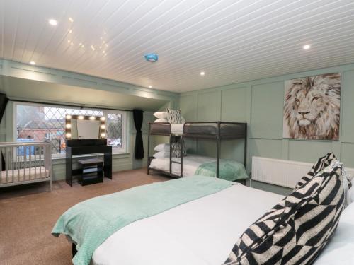 a bedroom with two bunk beds and a television at Seacrest Lodge in Scarborough