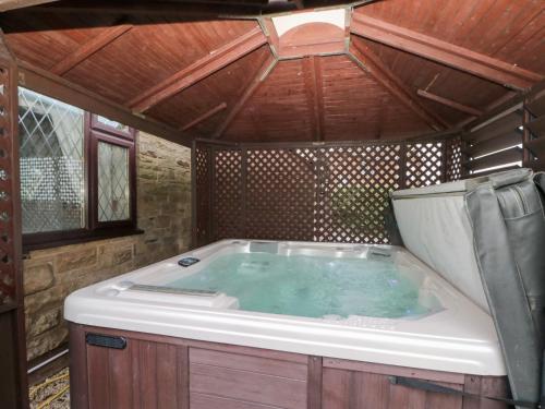 a jacuzzi tub in a house with a wooden ceiling at Seacrest Lodge in Scarborough