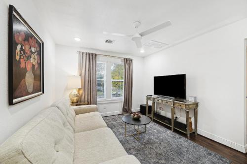 a living room with a couch and a tv at Upscale 1BED Apartment near FIFA - NRG Stadium, Med Center, and Downtown in Houston