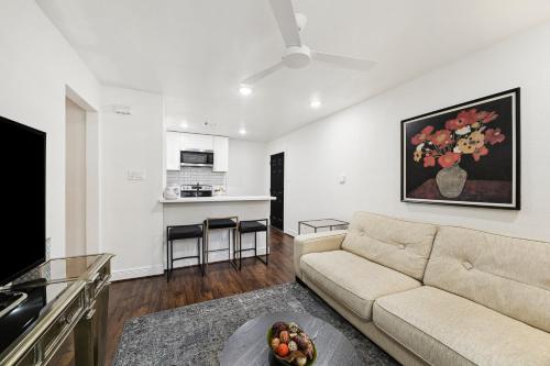 a living room with a couch and a kitchen at Upscale 1BED Apartment near FIFA - NRG Stadium, Med Center, and Downtown in Houston