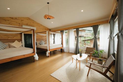 a bedroom with two bunk beds and a table at Campgrounds at Mantalongon in Dalaguete