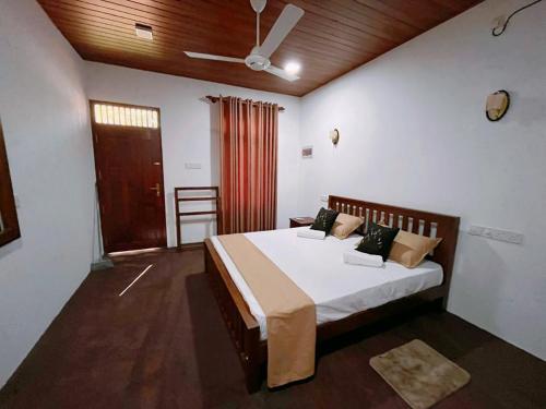 a bedroom with a large bed in a room at Villa Mistica - Hiriketiya Dikwella in Dickwella
