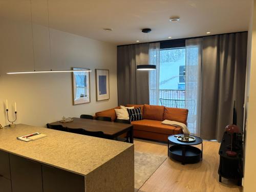 a kitchen and living room with a couch and a table at Levi Fjällen 6 in Levi