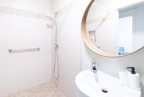a bathroom with a sink and a mirror at 3Beds Ground-Level Private Suite in Burnaby in Burnaby