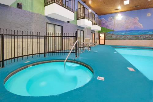 a swimming pool in a building with a blue floor at Days Inn by Wyndham East Albuquerque 'Newly Renovated' in Albuquerque