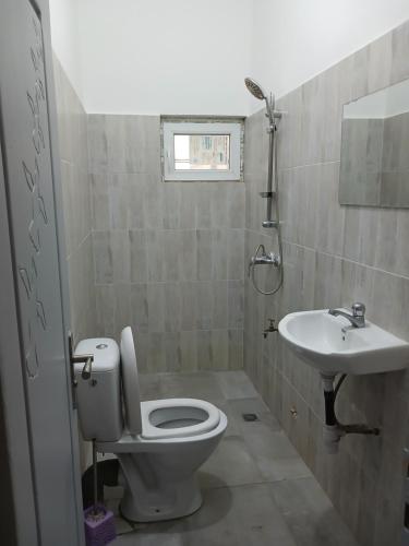a bathroom with a toilet and a sink at Christal house in Abomey-Calavi