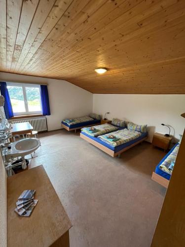 a large room with two beds and a table at Hospezi Santa Maria in Platta