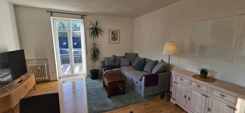 a living room with a couch and a tv at Ferienwohnung Lucia Amorbach in Amorbach