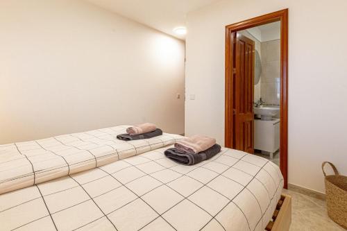 a bedroom with a bed with two pillows on it at El Nido Apartment in Acantilado de los Gigantes