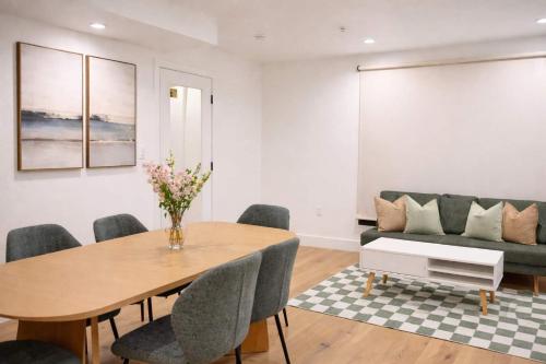 a living room with a table and a couch at Calm Luxe Ensuite Room near USC-Shared Home in Los Angeles