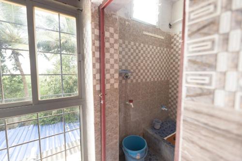 a bathroom with a shower with a window at MAS Residency Home in Pudukkottai