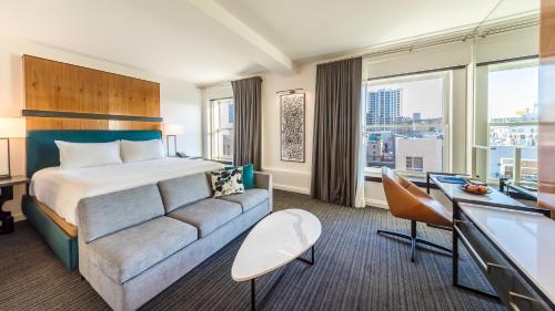 a hotel room with a bed and a couch at Andaz San Diego, By Hyatt in San Diego