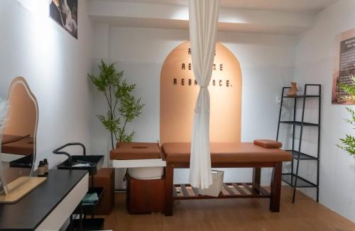 a dressing room with a table and a surfboard on the wall at Sala Hoi An Hotel in Hoi An