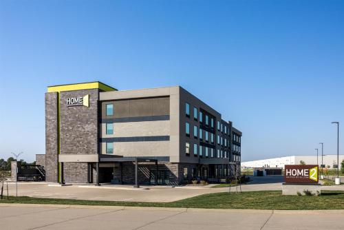 a building with a home sign in front of it at Home2 Suites By Hilton Altoona Des Moines in Altoona