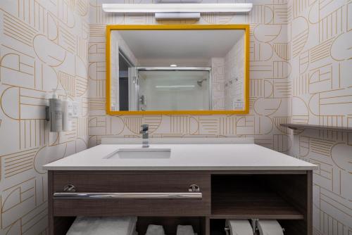 a bathroom with a sink and a mirror at Home2 Suites By Hilton Altoona Des Moines in Altoona