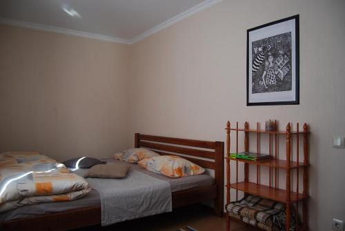 a bedroom with two beds and a shelf at Apartment on Knyahyni Ol'hy Street in Rivne
