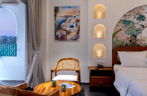 a bedroom with a bed and a table and a chair at Larissa Resort in Nashik