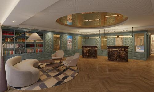 a library with chairs and a table and books at Tivoli Coimbra Hotel in Coimbra