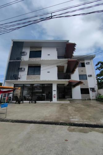 a large white building with a lot of windows at Eva's Guest House in General Luna