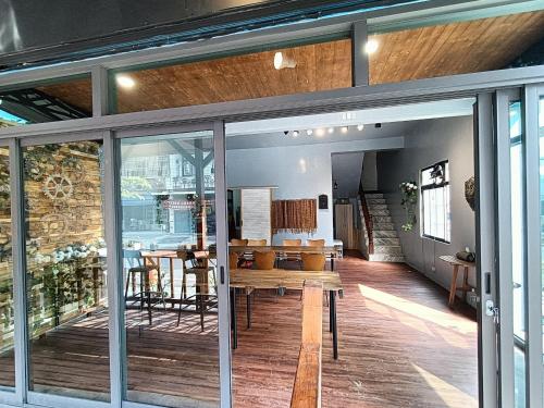 a room with sliding glass doors and a table at 那瑪夏Lu-Mah民宿 in Min-tsu